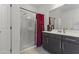 Modern bathroom featuring a glass shower and vanity with a dark wood cabinet at 11607 W Marguerite Ave, Avondale, AZ 85323