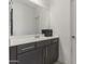 Clean bathroom featuring a modern vanity with cabinets and a large mirror at 11607 W Marguerite Ave, Avondale, AZ 85323