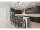 Gourmet kitchen featuring dark wood cabinets, sleek countertops, and a spacious center island at 11607 W Marguerite Ave, Avondale, AZ 85323