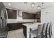 Gourmet kitchen featuring dark wood cabinets, sleek countertops, and a spacious center island at 11607 W Marguerite Ave, Avondale, AZ 85323
