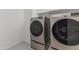 Modern laundry room featuring front-load washer and dryer with sleek design and functionality at 11607 W Marguerite Ave, Avondale, AZ 85323