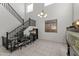 Bright living area featuring soaring ceilings, a modern staircase, and space for work and hobbies at 11607 W Marguerite Ave, Avondale, AZ 85323