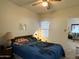 Comfortable bedroom with ceiling fan and a window offering natural light, with a bed and a nightstand at 145 N 74Th St # 236, Mesa, AZ 85207