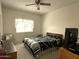 Inviting bedroom with ceiling fan and a large window offering natural light and a themed Raiders comforter set at 145 N 74Th St # 236, Mesa, AZ 85207