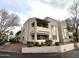 Modern condo building featuring a stucco exterior, balconies, desert landscaping and a speed limit sign of 15 mph at 145 N 74Th St # 236, Mesa, AZ 85207