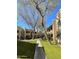 Exterior view of community buildings with lush landscaping and mature trees at 145 N 74Th St # 236, Mesa, AZ 85207