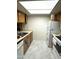 Well-lit kitchen with tile floor, wooden cabinets, and essential appliances for convenient meal preparation at 145 N 74Th St # 236, Mesa, AZ 85207
