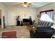 Cozy carpeted living room with ceiling fan, a sofa, a chair and a door leading to another room in the house at 145 N 74Th St # 236, Mesa, AZ 85207