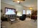 Comfortable living room featuring plush seating, large windows, and a classic ceiling fan and a coffee table at 145 N 74Th St # 236, Mesa, AZ 85207