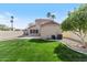 Spacious backyard features manicured lawn, mature trees, and block fence at 1518 E Mineral Rd, Gilbert, AZ 85234