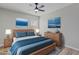 Inviting bedroom with a wooden bed frame, blue bedding, and ocean-themed wall art at 1518 E Mineral Rd, Gilbert, AZ 85234
