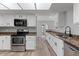 Bright kitchen featuring stainless steel appliances, granite countertops, and white cabinets for a modern, clean aesthetic at 1518 E Mineral Rd, Gilbert, AZ 85234