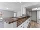 Updated kitchen bar with granite countertops, white cabinets and laminate floors provides a sleek and functional design at 1518 E Mineral Rd, Gilbert, AZ 85234