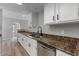 Stylish kitchen featuring granite countertops, white cabinets, and stainless steel appliances for a modern appeal at 1518 E Mineral Rd, Gilbert, AZ 85234