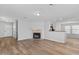 Spacious living room featuring laminate flooring, a fireplace, and an open layout with access to other living spaces at 1518 E Mineral Rd, Gilbert, AZ 85234