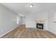 Bright living room featuring a cozy fireplace, neutral paint, and laminate floors for a comfortable ambiance at 1518 E Mineral Rd, Gilbert, AZ 85234