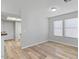 Open-concept living room with wood-look floors and large windows at 1518 E Mineral Rd, Gilbert, AZ 85234
