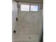 Luxurious shower with rainfall showerhead and marble-look tile at 1518 E Mineral Rd, Gilbert, AZ 85234