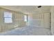 Unfinished bedroom featuring drywall, two windows, and a door for convenience at 15709 W Beryl Ave, Waddell, AZ 85355