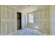 A bedroom featuring a window and a closet with a sliding door, offering a simple yet functional space at 15709 W Beryl Ave, Waddell, AZ 85355
