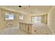 Spacious unfinished living room with large windows and sliding glass doors to backyard at 15709 W Beryl Ave, Waddell, AZ 85355