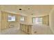Spacious unfinished living room featuring large windows and a sliding glass door to the backyard at 15709 W Beryl Ave, Waddell, AZ 85355
