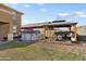 Backyard with a gazebo, an above ground pool, a well-kept lawn, and an outdoor bench at 18040 W Louise Dr, Surprise, AZ 85387