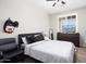 Cozy bedroom featuring a ceiling fan, window with shutters, and neutral color scheme at 18040 W Louise Dr, Surprise, AZ 85387