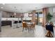 Cozy dining area featuring a modern round table and open access to the kitchen at 18040 W Louise Dr, Surprise, AZ 85387
