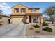 Charming two-story home with desert landscaping and a cozy front porch area at 18040 W Louise Dr, Surprise, AZ 85387
