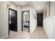 Hallway showcasing dark interior doors, wood-look floors, and access to a bedroom and bathroom at 18040 W Louise Dr, Surprise, AZ 85387