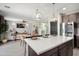 Modern kitchen with a quartz countertop island and open layout to the living space at 18040 W Louise Dr, Surprise, AZ 85387
