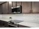 A well-equipped kitchen features quartz countertops, subway tile backsplash and stainless steel appliances at 18040 W Louise Dr, Surprise, AZ 85387