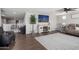 A well-lit living room features a ceiling fan, modern decor and wood-look flooring at 18040 W Louise Dr, Surprise, AZ 85387