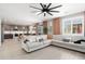 Open-concept living space with a sectional sofa, kitchen island, and dining area at 18040 W Louise Dr, Surprise, AZ 85387