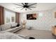 Stylish living room featuring a brick accent wall, modern furniture, and a ceiling fan at 18040 W Louise Dr, Surprise, AZ 85387