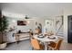 Stylish open-concept living space with a dining area and a cozy living room at 18040 W Louise Dr, Surprise, AZ 85387