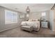 Spacious main bedroom featuring a plush bed, elegant lighting, and cozy decor for a relaxing retreat at 18040 W Louise Dr, Surprise, AZ 85387