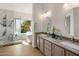 Elegant bathroom featuring double sinks, a soaking tub, and a luxurious marble shower at 1837 E Catamaran Dr, Gilbert, AZ 85234