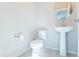 Stylish half-bathroom featuring a modern pedestal sink and toilet at 19801 W Badgett Ln, Litchfield Park, AZ 85340
