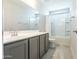 Bright bathroom with a full vanity, mirror, and a shower and bathtub combo at 19801 W Badgett Ln, Litchfield Park, AZ 85340