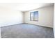 Clean, carpeted bedroom featuring a window with a backyard view at 19801 W Badgett Ln, Litchfield Park, AZ 85340