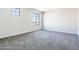 Bedroom showcasing plush carpet, neutral paint, and a well-lit window at 19801 W Badgett Ln, Litchfield Park, AZ 85340