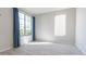 Bedroom featuring neutral walls, floor tiles, and dual pane windows with curtains at 19801 W Badgett Ln, Litchfield Park, AZ 85340