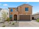 Charming two-story home featuring a front yard with low-maintenance landscaping and a two-car garage at 19801 W Badgett Ln, Litchfield Park, AZ 85340