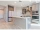 Bright kitchen featuring an island, modern appliances, sleek cabinets, and a stylish tile floor at 19801 W Badgett Ln, Litchfield Park, AZ 85340