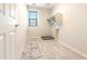 Functional laundry room features modern tile flooring and convenient utility connections at 19801 W Badgett Ln, Litchfield Park, AZ 85340