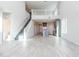 Open-concept living room showcases a staircase, kitchen view, and an abundance of natural light at 19801 W Badgett Ln, Litchfield Park, AZ 85340