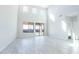 Spacious living room with high ceilings, large windows, and an open floor plan featuring tiled floors at 19801 W Badgett Ln, Litchfield Park, AZ 85340