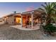 Spacious backyard featuring a covered patio, desert landscaping, and ample space for outdoor activities and relaxation at 19975 N Crescent Way, Surprise, AZ 85374